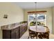 Bright breakfast nook with wood table and built in cabinetry at 1494 Walnut Way, The Villages, FL 32163