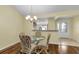 Charming dining area with hardwood floors and glass top table at 1494 Walnut Way, The Villages, FL 32163