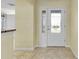 Bright foyer with a white door and glass inserts at 1494 Walnut Way, The Villages, FL 32163