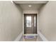 Inviting entryway with a dark brown door and welcome mat at 1494 Walnut Way, The Villages, FL 32163