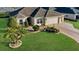 Single-story house with two-car garage and landscaped yard at 1494 Walnut Way, The Villages, FL 32163