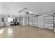 Spacious two-car garage with epoxy flooring and ample storage at 1494 Walnut Way, The Villages, FL 32163