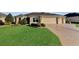 Beautiful house with well-manicured lawn and driveway at 1494 Walnut Way, The Villages, FL 32163