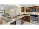Modern kitchen with stainless steel appliances and granite countertops at 1494 Walnut Way, The Villages, FL 32163