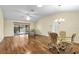 Spacious living room with hardwood floors and access to the patio at 1494 Walnut Way, The Villages, FL 32163