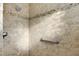 Large tiled shower with built-in seat and grab bars at 1494 Walnut Way, The Villages, FL 32163