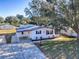 Single story home in a residential neighborhood with mature trees at 1611 Cherry Hill Rd, The Villages, FL 32159