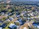Aerial view showing a home nestled in a wooded 55+ community at 1611 Cherry Hill Rd, The Villages, FL 32159