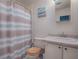 Bathroom with striped shower curtain and vanity at 1611 Cherry Hill Rd, The Villages, FL 32159
