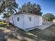 Rear view of a home with garage and covered carport at 1611 Cherry Hill Rd, The Villages, FL 32159