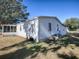 Side view of a single story home with AC unit and large yard at 1611 Cherry Hill Rd, The Villages, FL 32159