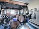 Spacious golf cart garage with storage shelving and golf clubs at 1611 Cherry Hill Rd, The Villages, FL 32159