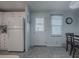 Bright kitchen features white cabinets, appliances, and vinyl flooring at 1611 Cherry Hill Rd, The Villages, FL 32159