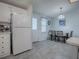 White kitchen with appliances and dining area at 1611 Cherry Hill Rd, The Villages, FL 32159