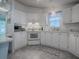 White kitchen with corner sink and modern appliances at 1611 Cherry Hill Rd, The Villages, FL 32159