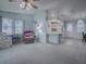 Living room features carpeting, a ceiling fan, and comfy seating at 1611 Cherry Hill Rd, The Villages, FL 32159