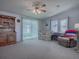 Spacious living room with carpeting, ceiling fan, and seating area at 1611 Cherry Hill Rd, The Villages, FL 32159