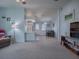 Living room with carpeting, ceiling fan, and access to enclosed patio at 1611 Cherry Hill Rd, The Villages, FL 32159