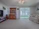 Living room with a view of enclosed patio and built-in hutch at 1611 Cherry Hill Rd, The Villages, FL 32159