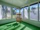 Relaxing sunroom with rocking chair and green carpet at 1611 Cherry Hill Rd, The Villages, FL 32159