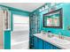 Teal bathroom with double vanity, soaking tub, and shower at 1725 Strathmore Cir, Mount Dora, FL 32757