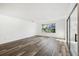 Sunlit living room with vinyl plank flooring and access to patio at 17694 Se 84Th Peyton Ct, The Villages, FL 32162