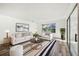 Living room with comfy seating, stylish rug and large window at 17694 Se 84Th Peyton Ct, The Villages, FL 32162