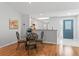 Cozy dining area with glass table and chairs, adjacent to kitchen at 17872 Se 86Th Oak Leaf Ter, The Villages, FL 32162