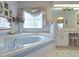 Elegant bathroom with a large corner jacuzzi tub, vanity and tiled flooring at 21502 King Henry Ave, Leesburg, FL 34748