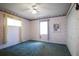 Simple bedroom with carpeted floor, window, and floral wallpaper at 21502 King Henry Ave, Leesburg, FL 34748