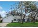 Inviting single-story home with a two-car garage and well-manicured lawn at 21502 King Henry Ave, Leesburg, FL 34748