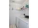 Laundry room with washer, dryer, and wire shelving at 21502 King Henry Ave, Leesburg, FL 34748