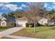 One-story house with attached garage and mature tree in front at 2354 Valhalla Dr, Tavares, FL 32778