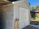 Large storage shed with double doors and a small deck at 2478 Cr 447, Lake Panasoffkee, FL 33538