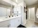 Modern bathroom with double vanity, white cabinets, and a walk-in shower at 30224 Armenia Rd, Leesburg, FL 34748