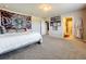 Main bedroom with a large bed, artwork, and access to a bathroom at 30224 Armenia Rd, Leesburg, FL 34748
