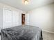 Bedroom with double closet and gray bedding at 30224 Armenia Rd, Leesburg, FL 34748
