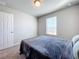 Simple bedroom with window and gray bedding at 30224 Armenia Rd, Leesburg, FL 34748