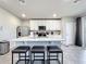 Modern kitchen with white cabinets, stainless steel appliances, and an island with seating at 30224 Armenia Rd, Leesburg, FL 34748