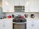 Modern kitchen with stainless steel stove and microwave at 30224 Armenia Rd, Leesburg, FL 34748
