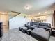 Living room with sectional sofa, large TV, and tile floors at 30224 Armenia Rd, Leesburg, FL 34748