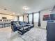 Living room with sectional sofa, large TV, and tile floors at 30224 Armenia Rd, Leesburg, FL 34748