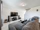 Living room with sectional sofa, large TV, and tile floors at 30224 Armenia Rd, Leesburg, FL 34748