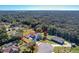 Aerial view of a two-story house on a spacious lot with surrounding woodland at 30812 Top Of The Hill Dr, Mount Dora, FL 32757