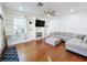 Living room with hardwood floors, built-in shelving and sectional sofa at 30812 Top Of The Hill Dr, Mount Dora, FL 32757