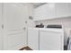 Laundry room with washer, dryer, and overhead cabinets at 3240 Hampton Ln, The Villages, FL 32162