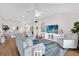 Living room with hardwood floors, a large sofa, and sliding doors to a patio at 3240 Hampton Ln, The Villages, FL 32162