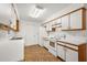 Efficient galley kitchen with white cabinets and patterned flooring at 33427 Picciola Dr, Fruitland Park, FL 34731