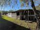 Mobile home with screened porch and side yard at 34927 1St Ave, Leesburg, FL 34788