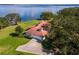 Aerial view of house with lakefront access and lush landscaping at 38230 Yale Cir, Leesburg, FL 34788